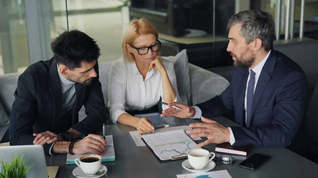 Business advisors discussing strategy over financial reports